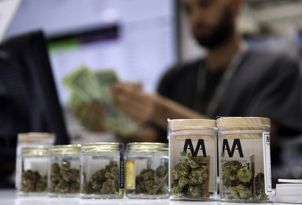 A cashier rings up a marijuana sale at the Essence cannabis dispensary in Las Vegas in 2017. (A ...
