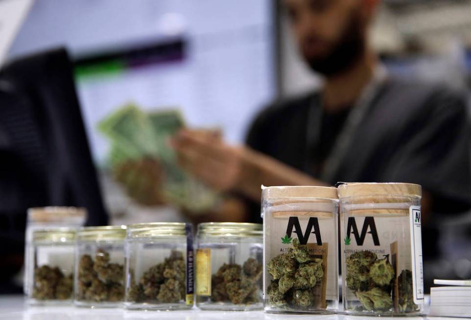 A cashier rings up a marijuana sale at the Essence cannabis dispensary in Las Vegas in 2017. (A ...