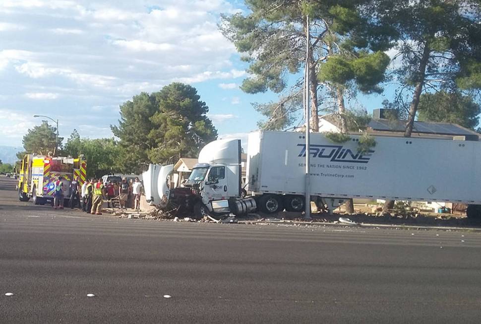 A semi-truck crashed into a residential brick wall on Windmill Lane at Wishing Well Road in Las ...