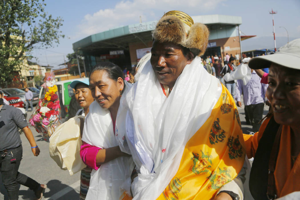 Nepalese veteran Sherpa guide Kami Rita, 49, is welcomed by his wife at the airport in Kathmand ...