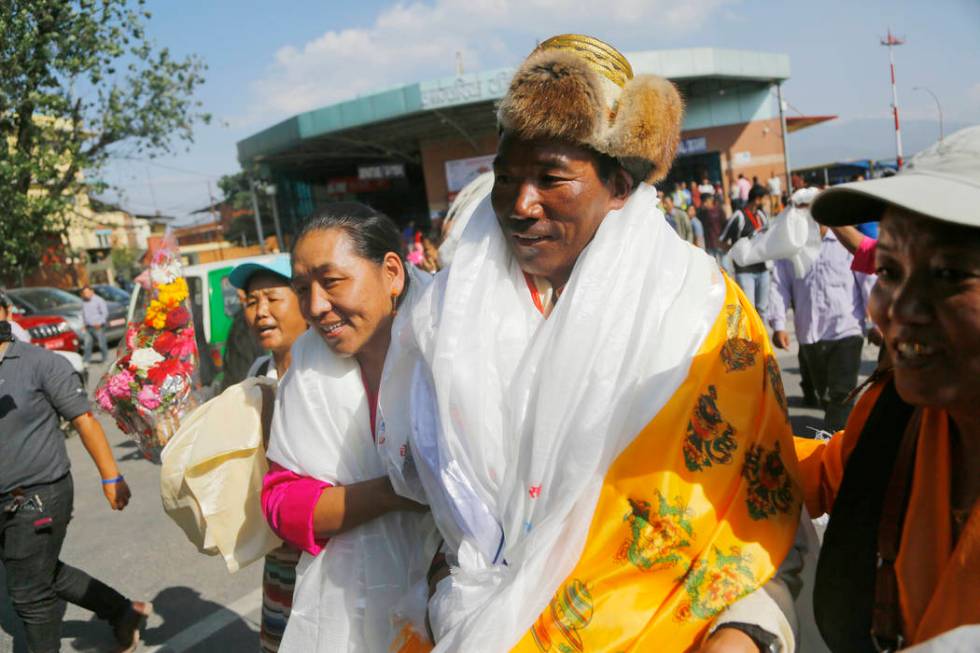 Nepalese veteran Sherpa guide Kami Rita, 49, is welcomed by his wife at the airport in Kathmand ...