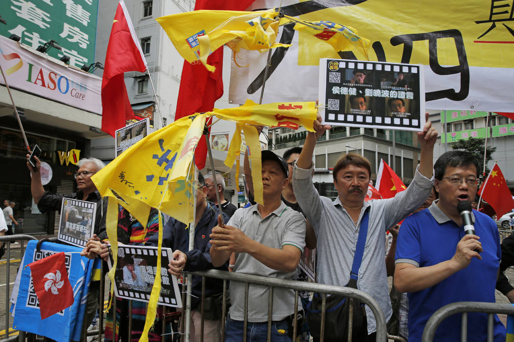 Pro-Beijing supporters destroy yellow umbrellas, used to mark protesting denouncing far-reachin ...