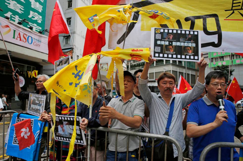 Pro-Beijing supporters destroy yellow umbrellas, used to mark protesting denouncing far-reachin ...