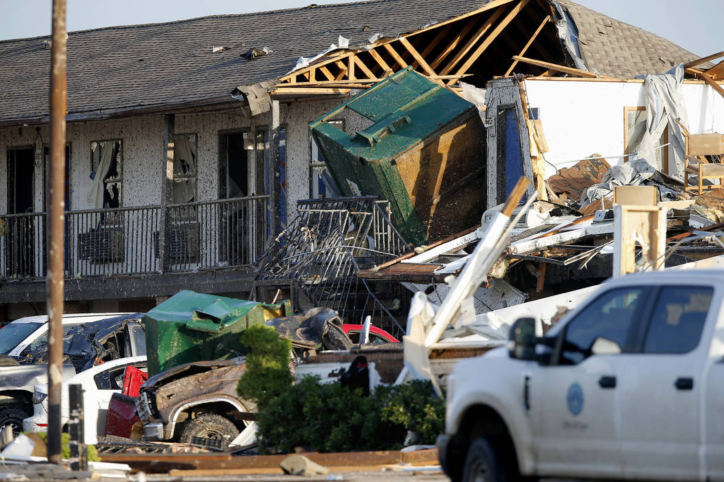 Part of a roof is exposed at the American Budget Value Inn after a tornado moved through the ar ...