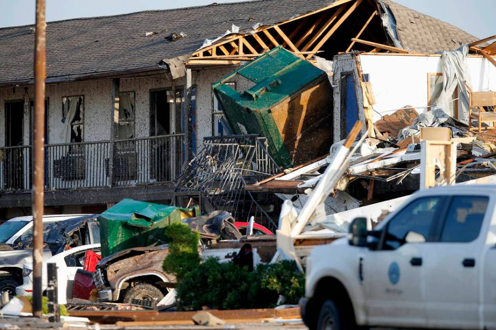 Part of a roof is exposed at the American Budget Value Inn after a tornado moved through the ar ...