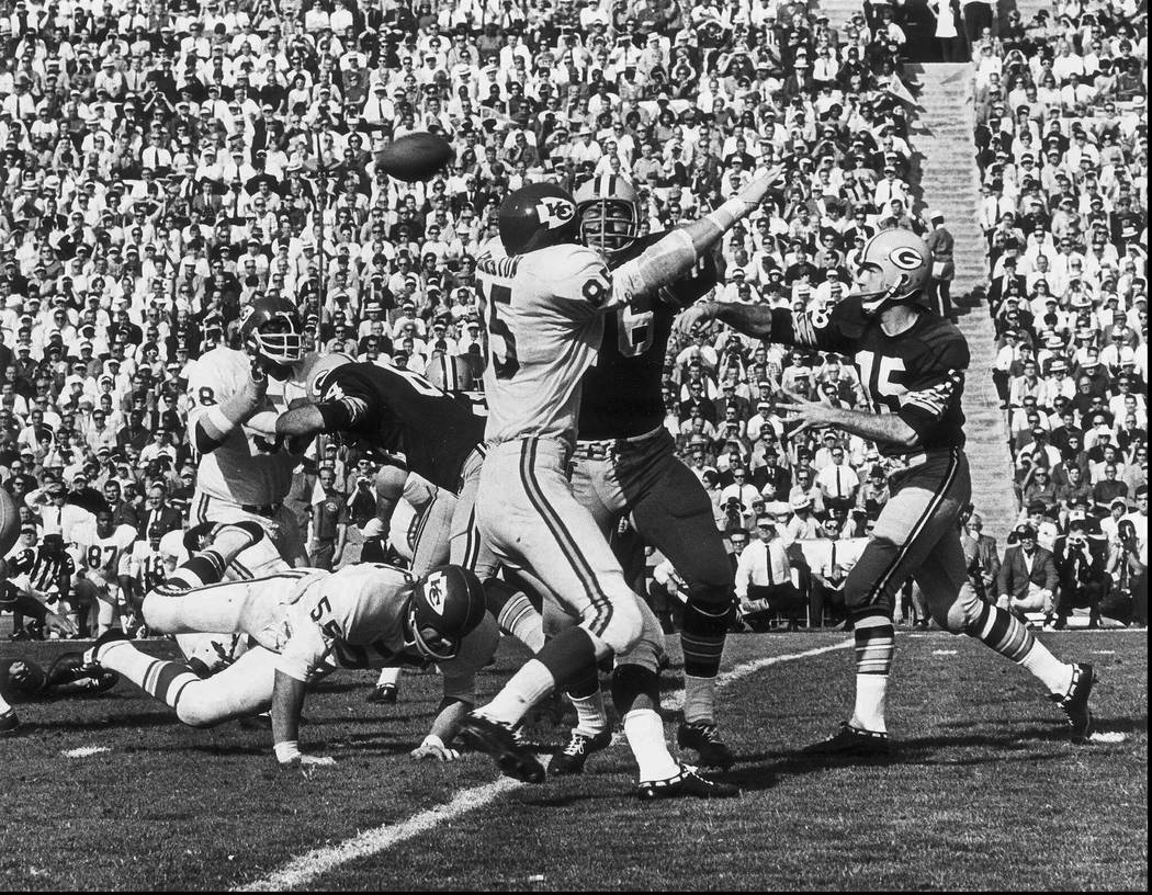 FILE - In this Jan. 16, 1967, file photo, Green Bay Packers quarterback Bart Starr, right, thro ...