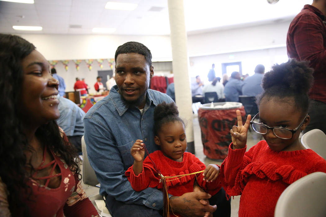 Inmate Daysean Jenkins, second from left, celebrates his graduation following a Youthful Offend ...