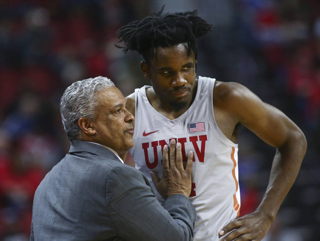UNLV Rebels head coach Marvin Menzies talks with forward Joel Ntambwe during the second half of ...