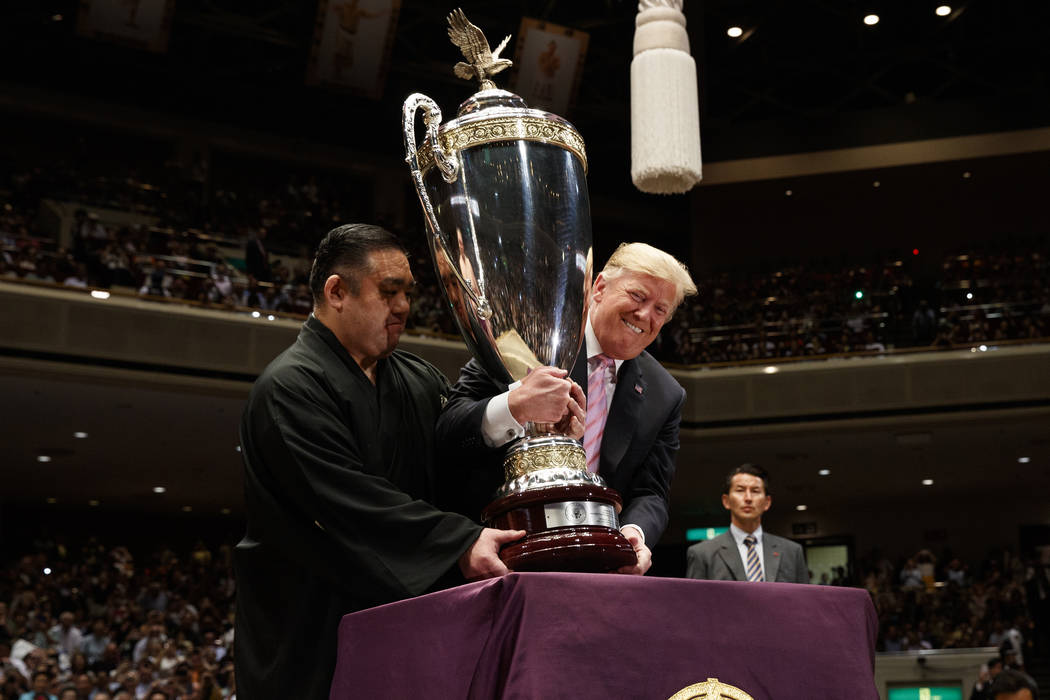 President Donald Trump picks up the "President's Cup" to present to the Tokyo Grand S ...