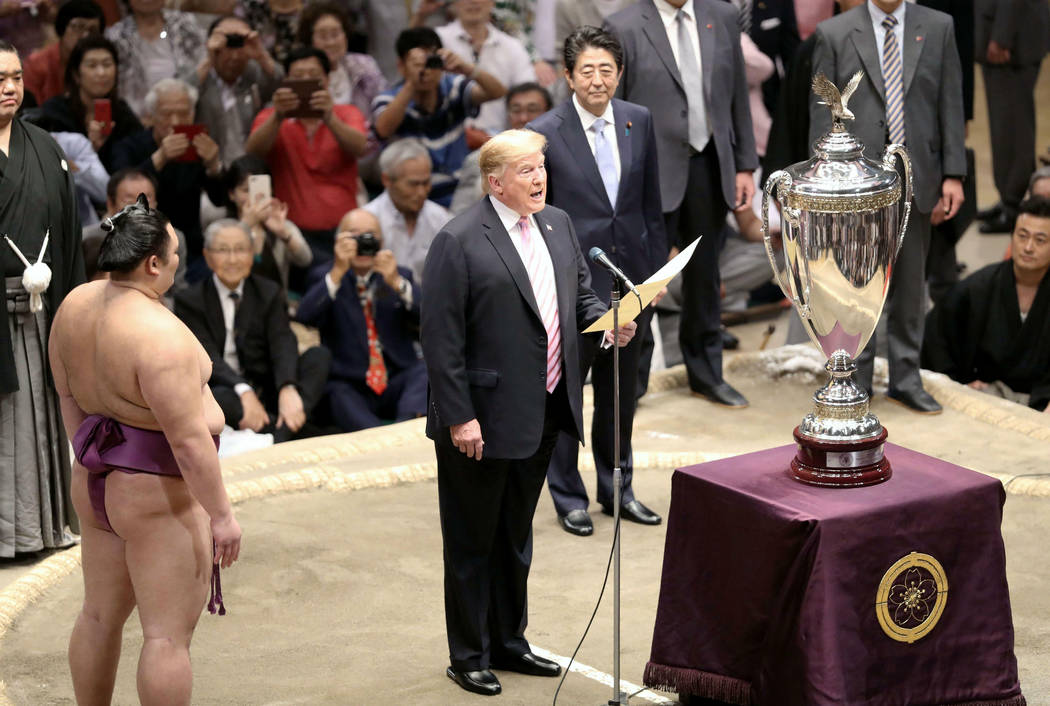 President Donald Trump, center, speaks as Trump presents the "President's Cup" trophy ...