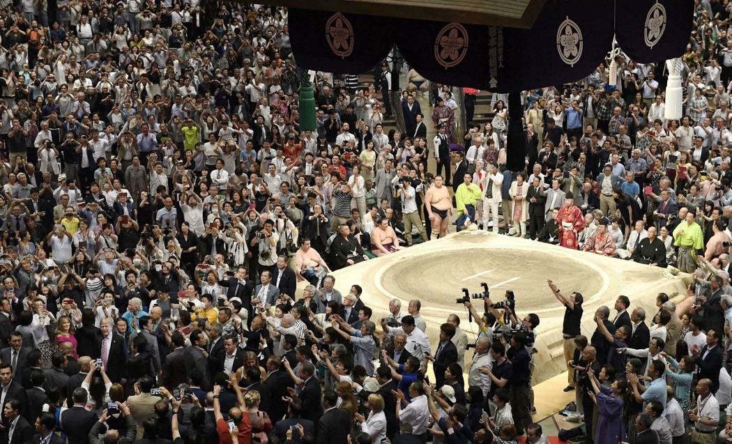 U.S. President Donald Trump, left bottom, with First Lady Melania Trump, waves to the spectator ...