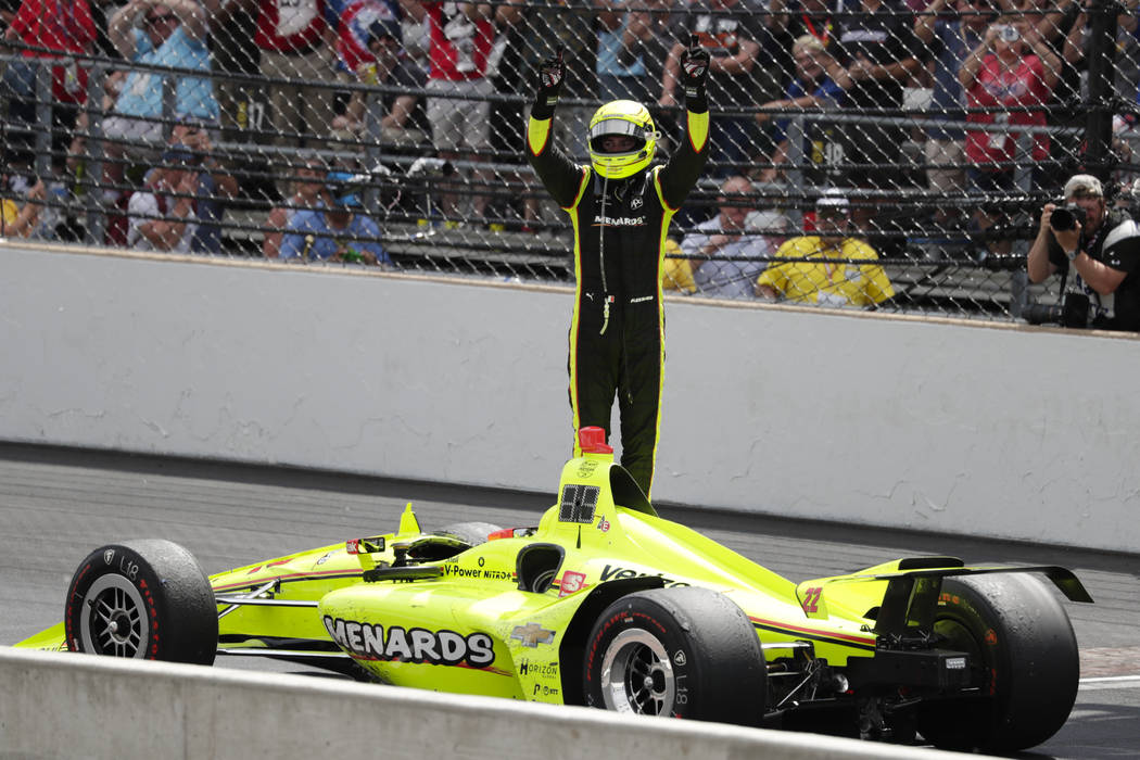 Simon Pagenaud, of France, celebrates after winning the Indianapolis 500 IndyCar auto race at I ...