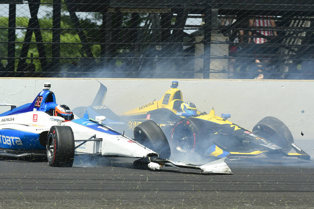 Felix Rosenqvist, of Sweden, left, and Zach Veach collide in the third turn during the Indianap ...