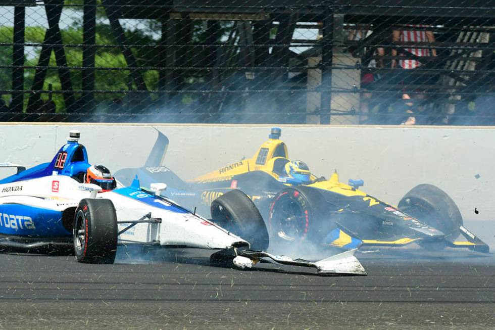Felix Rosenqvist, of Sweden, left, and Zach Veach collide in the third turn during the Indianap ...