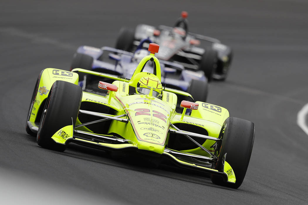 Simon Pagenaud, of France, leads a pack through the first turn during the Indianapolis 500 Indy ...