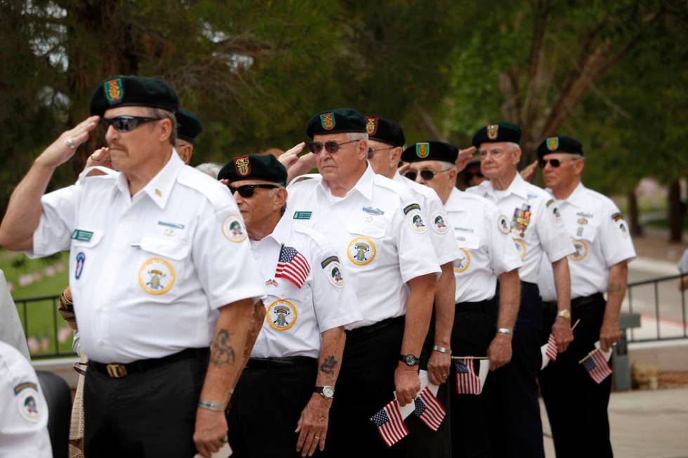 Members of the Special Forces Association salute during a ceremony to honor those who have died ...