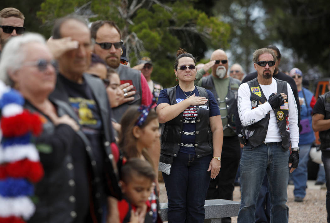 The crowd pledges allegiance to the flag during a ceremony to honor those who have died while s ...