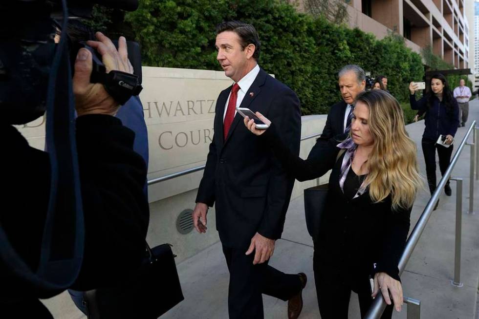 Republican Rep. Duncan Hunter, center, leaves court in San Diego, Dec. 3, 2018. Hunter has ackn ...