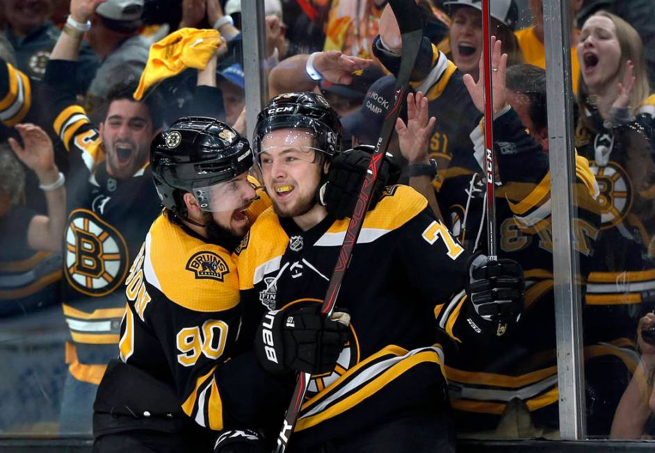 Boston Bruins' Charlie McAvoy, right, celebrates his goal against the St. Louis Blues with Marc ...