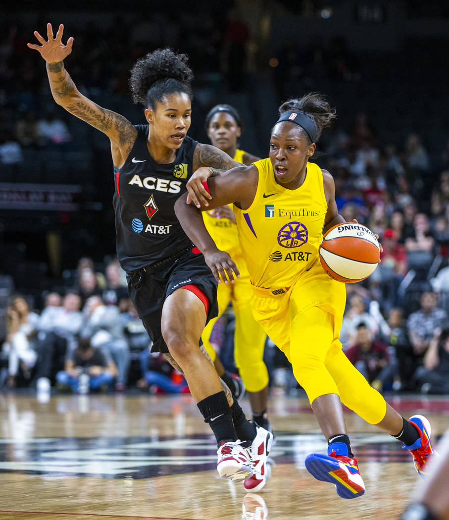 Las Vegas Aces forward Tamera Young (1) defends the lane from Los Angeles Sparks guard Chelsea ...