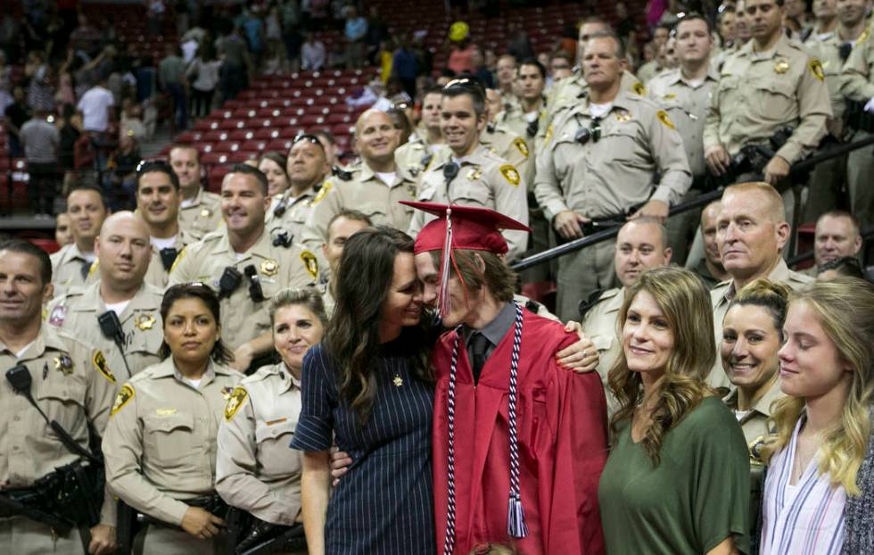 Daxton Beck gets a hug from his mother, Nicole, as they gather for a photo with a group of Las ...