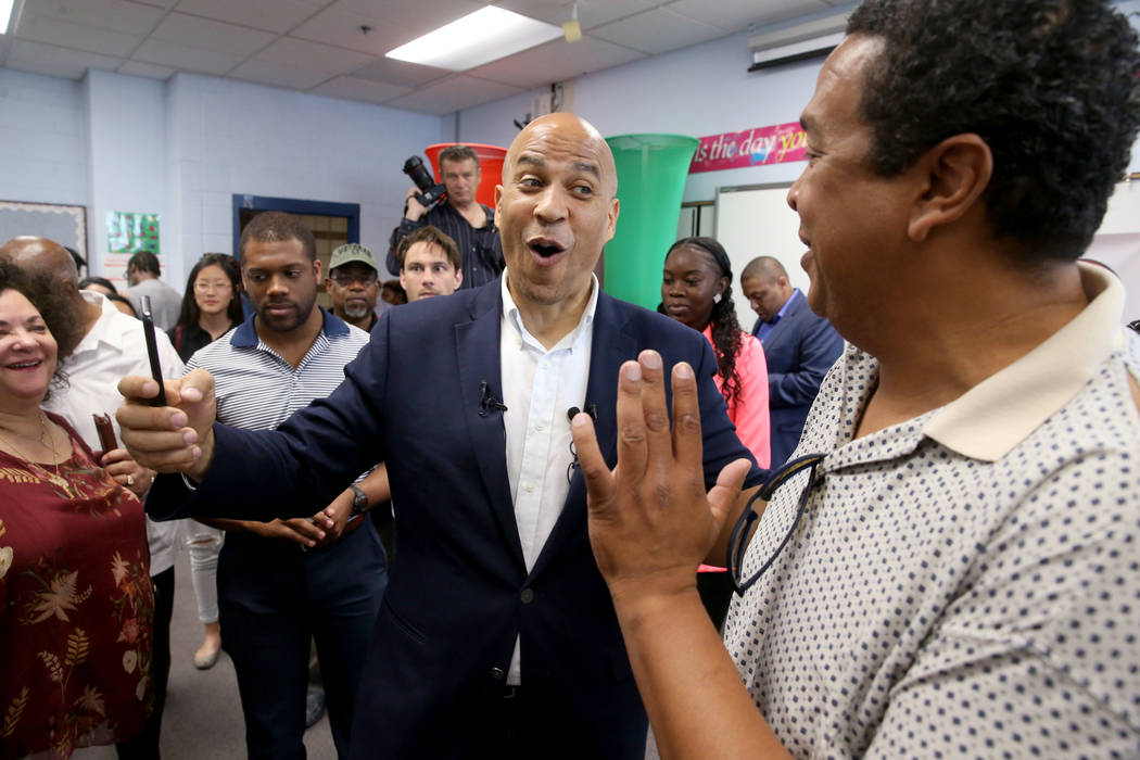 Presidential hopeful Sen. Cory Booker, D-N.J., left, visits with Stephen Munford after Student ...