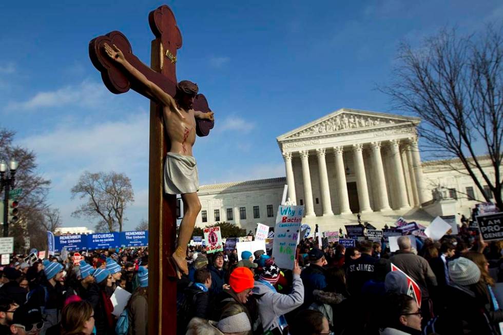 In this Friday, Jan. 18, 2019 file photo, anti-abortion activists march outside the U.S. Suprem ...