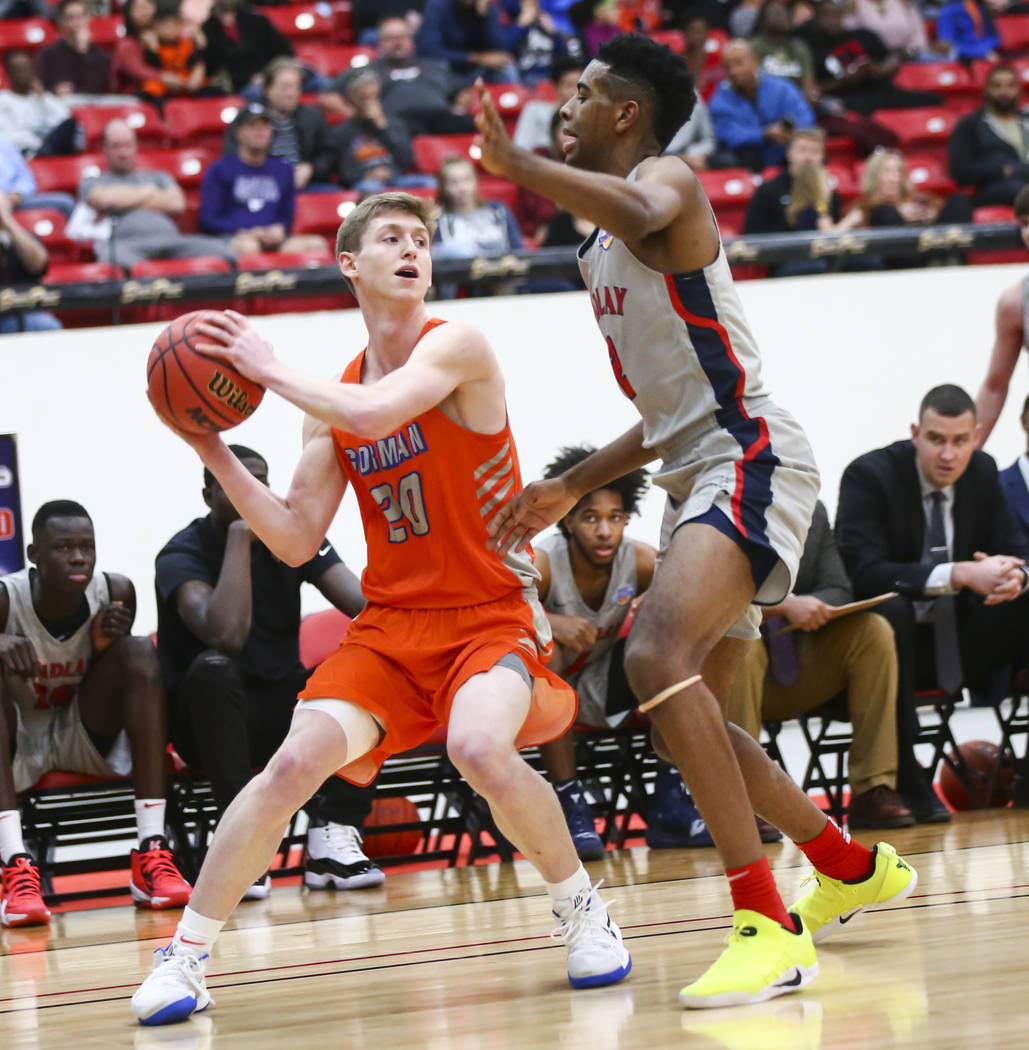 Bishop Gorman's Noah Taitz (20) tries to get the ball around Findlay Prep's Aston Smith during ...