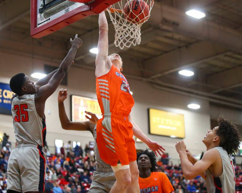 Bishop Gorman's Noah Taitz dunks in front of Findlay Prep's Alex Tchikou (35) during the first ...