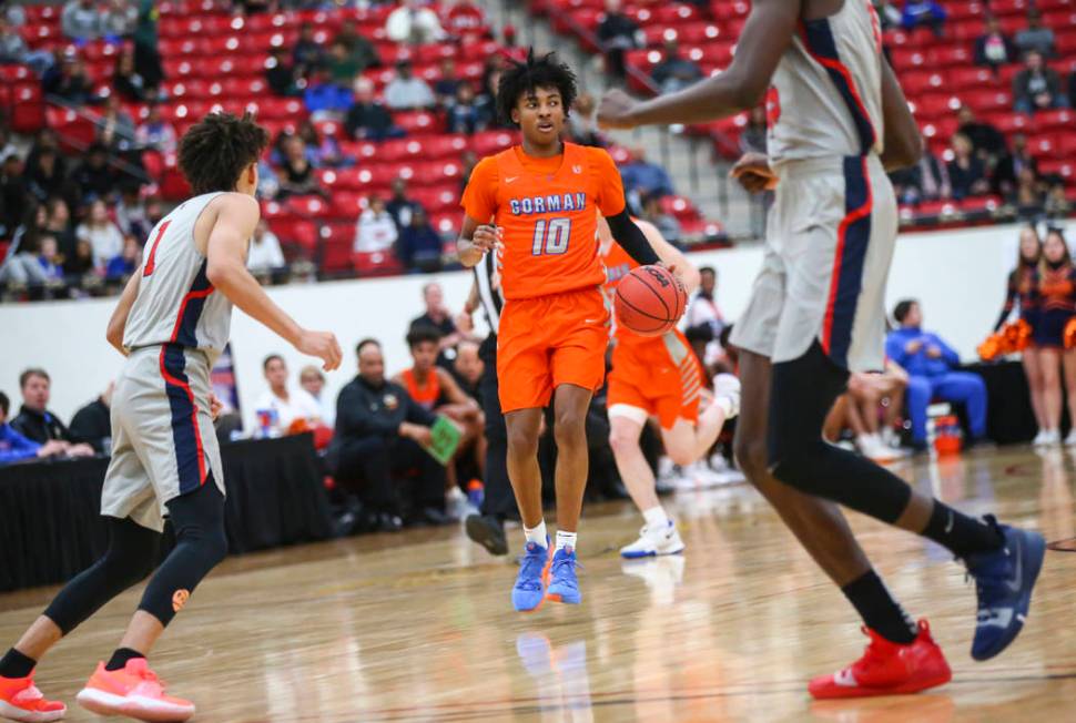 Bishop Gorman's Zaon Collins (10) brings the ball up court during the first half of the annual ...