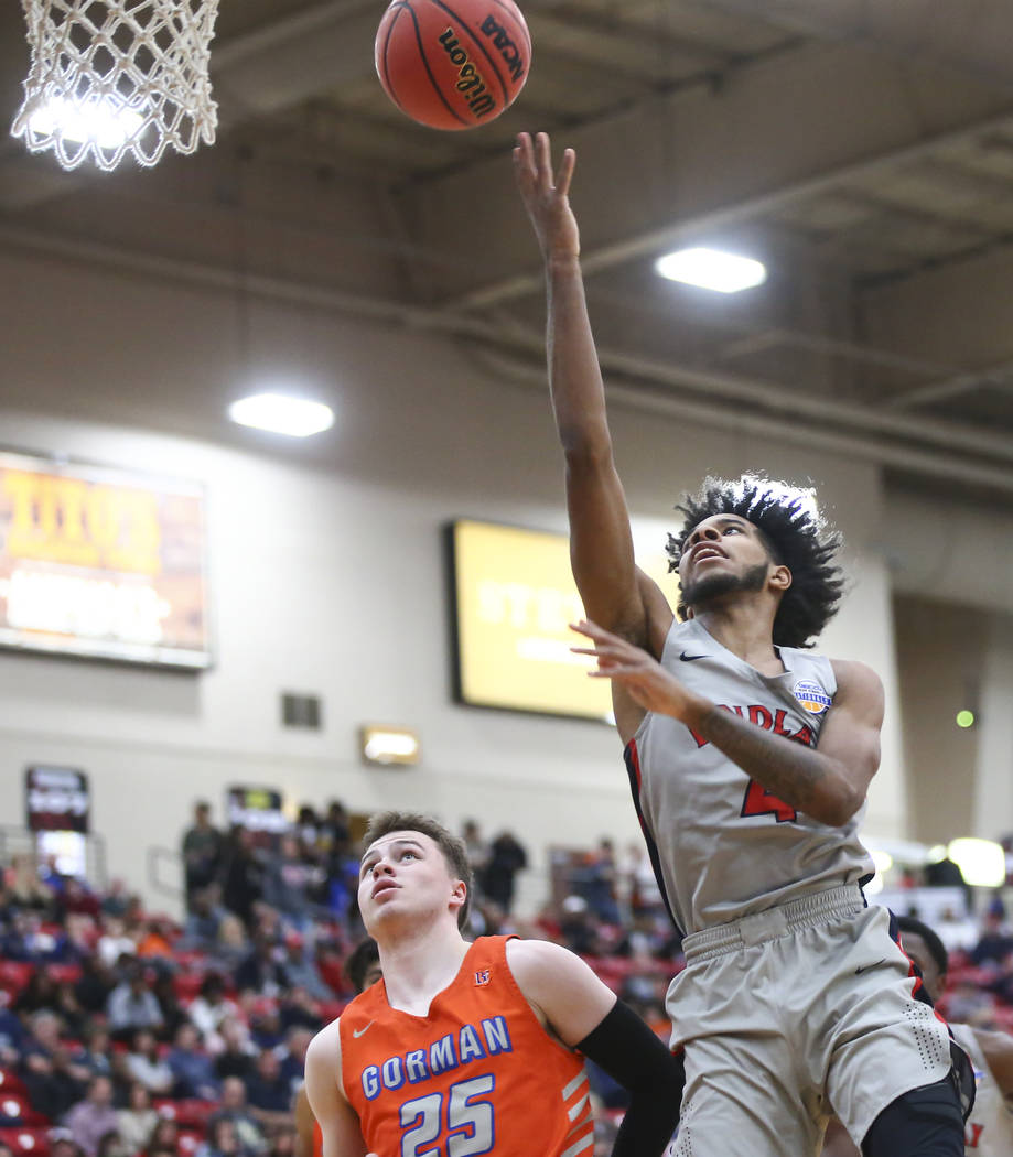 Findlay Prep's P.J. Fuller goes to the basket against Bishop Gorman's Chance Michels (25) durin ...