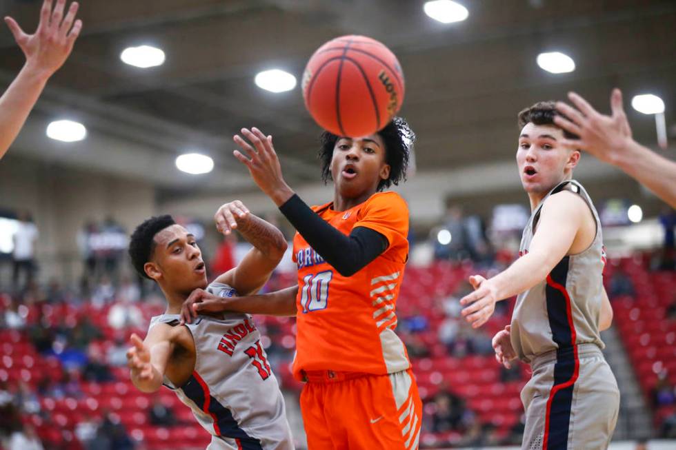 Bishop Gorman's Zaon Collins (10) watches a loose ball between Findlay Prep's Taryn Todd (11) a ...