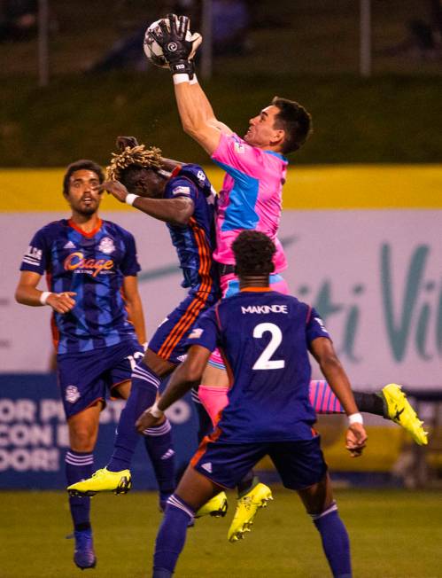 (From right) Las Vegas Lights FC goalkeeper Thomas Olsen (1) grabs a shot on goal over Tulsa Ro ...