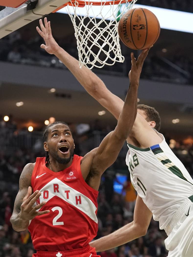 Toronto Raptors' Kawhi Leonard shoots past Milwaukee Bucks' Brook Lopez during the second half ...