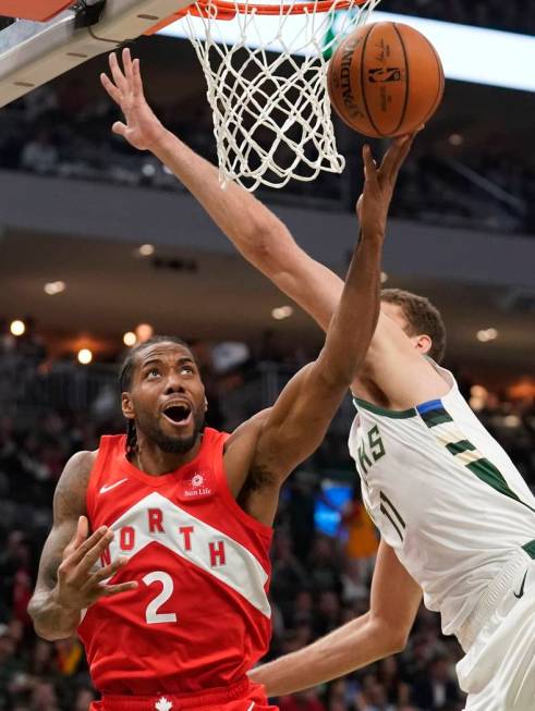 Toronto Raptors' Kawhi Leonard shoots past Milwaukee Bucks' Brook Lopez during the second half ...