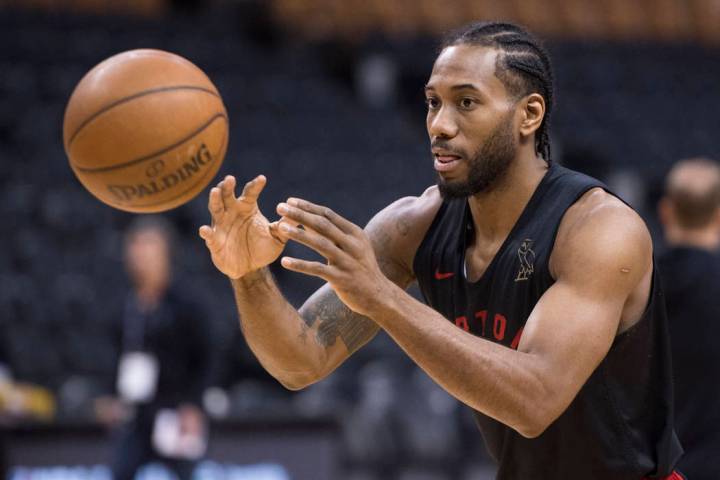 Toronto Raptors' Kawhi Leonard passes during practice for the NBA Finals in Toronto on Wednesda ...