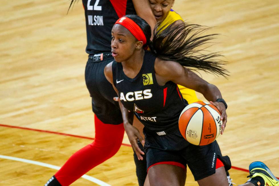 Las Vegas Aces guard Jackie Young (0) drives t6he lane past a pick by teammate center A'ja Wils ...