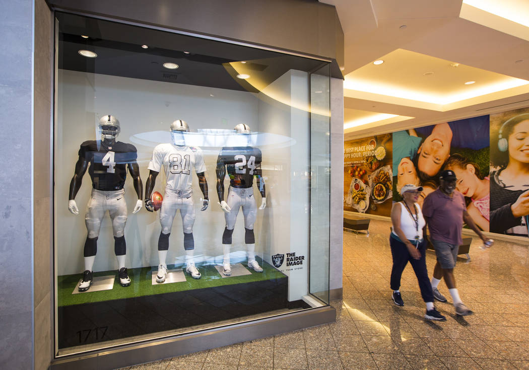 A couple passes by The Raider Image store at the Galleria at Sunset mall in Henderson on Wednes ...