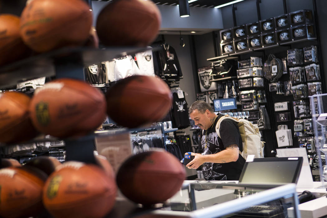 Nickolaus Gerencser, of Baldwin Park, Calif., buys items at The Raider Image store at the Galle ...