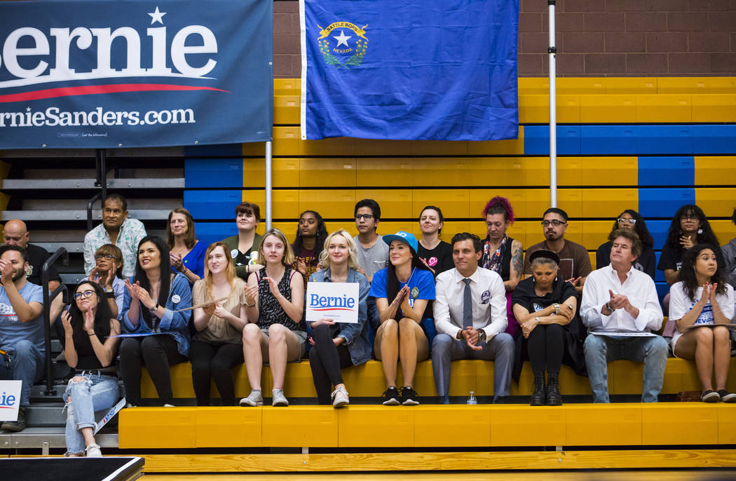 Supporters listen to Democratic presidential candidate Sen. Bernie Sanders, I-Vt., during a tow ...