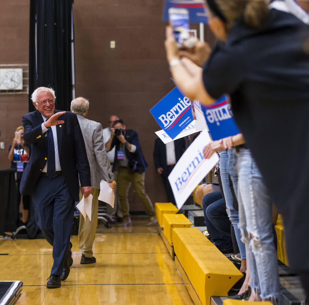 Democratic presidential candidate Sen. Bernie Sanders, I-Vt., motions to the crowd at a town ha ...