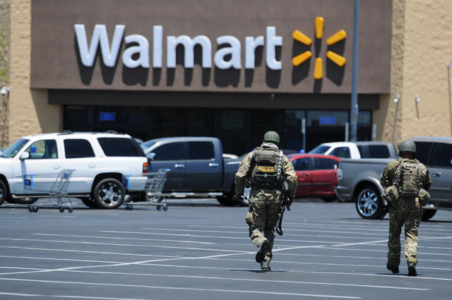 Two Las Vegas police officers rush to a Walmart near Nellis Boulevard and Stewart Avenue on Jun ...