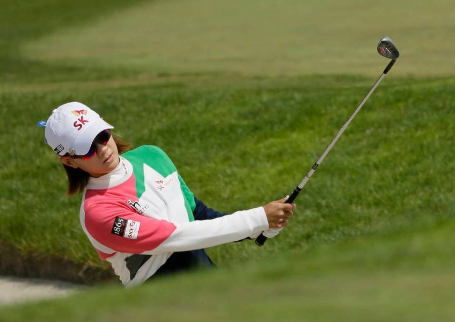 Na Yeon Choi, of South Korea, hits out of a bunker up to the fifth green of the Lake Merced Gol ...