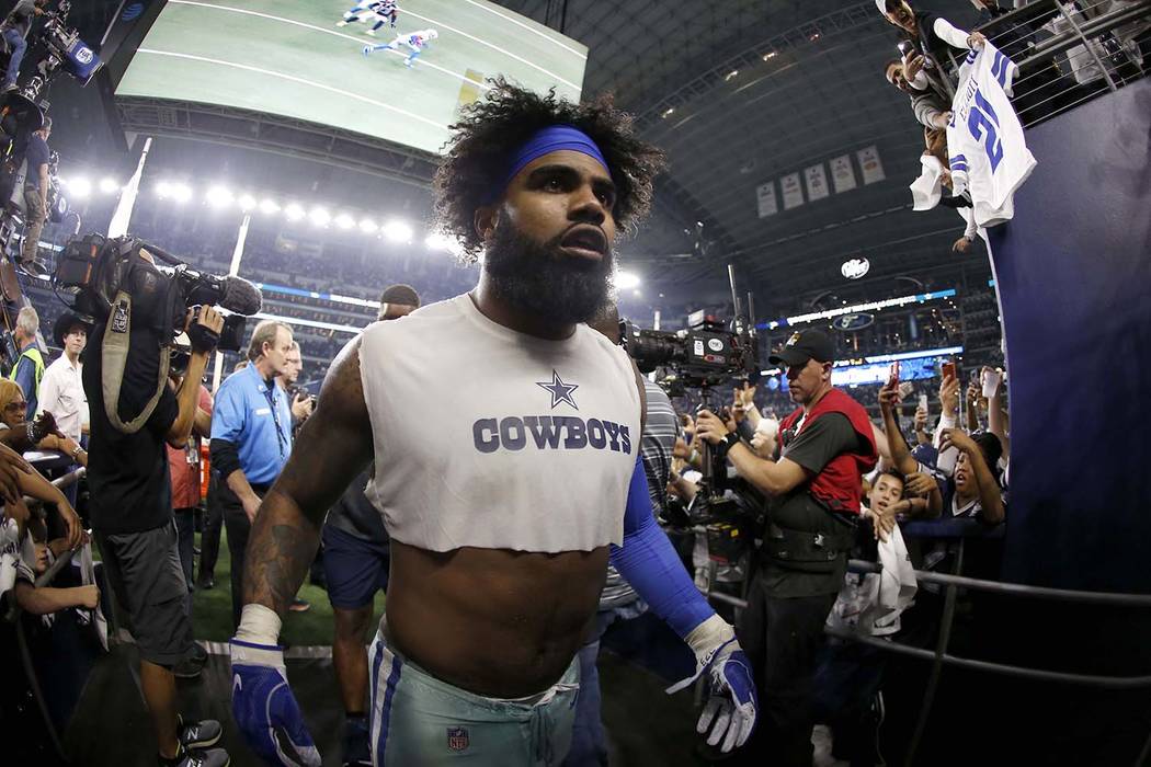 Dallas Cowboys running back Ezekiel Elliott (21) heads to the clubhouse after an NFC wild-card ...