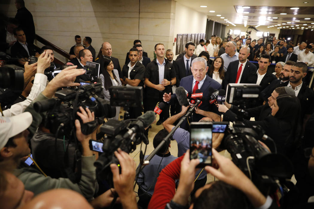 Israeli Prime Minister Benjamin Netanyahu speaks to the media after voting in the Knesset, Isra ...