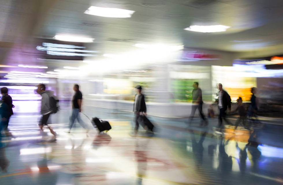 Travelers walk through baggage claim in Terminal 1 at McCarran International Airportin Las Vega ...