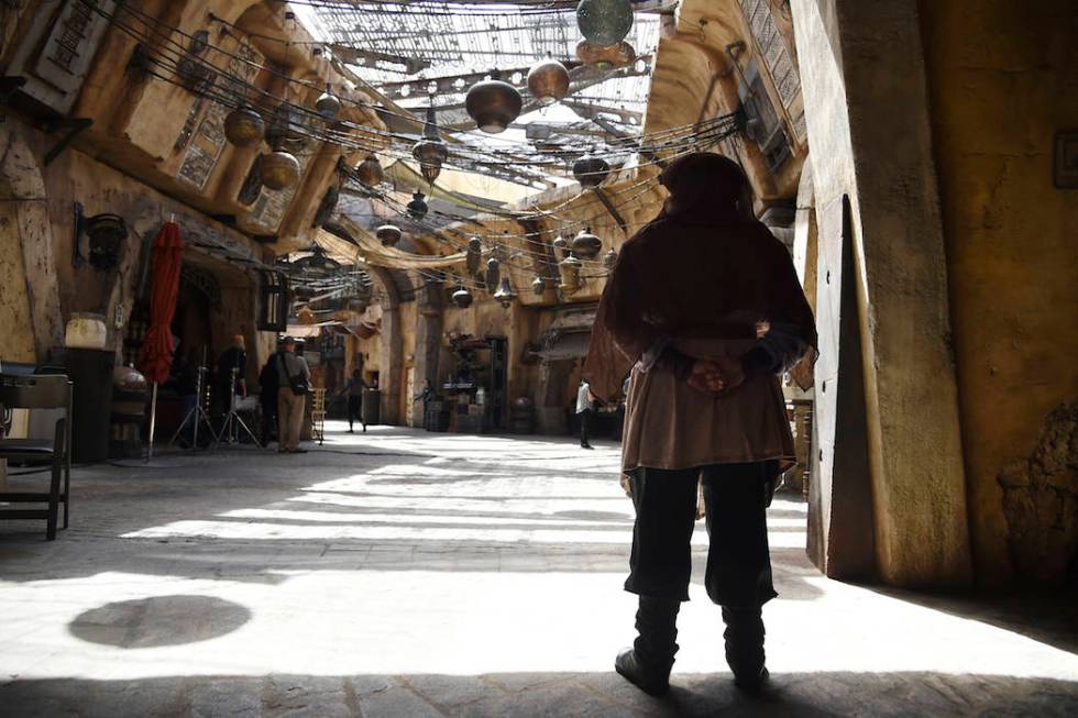 A character looks out to the marketplace in the Black Spire Outpost during the Star Wars: Galax ...