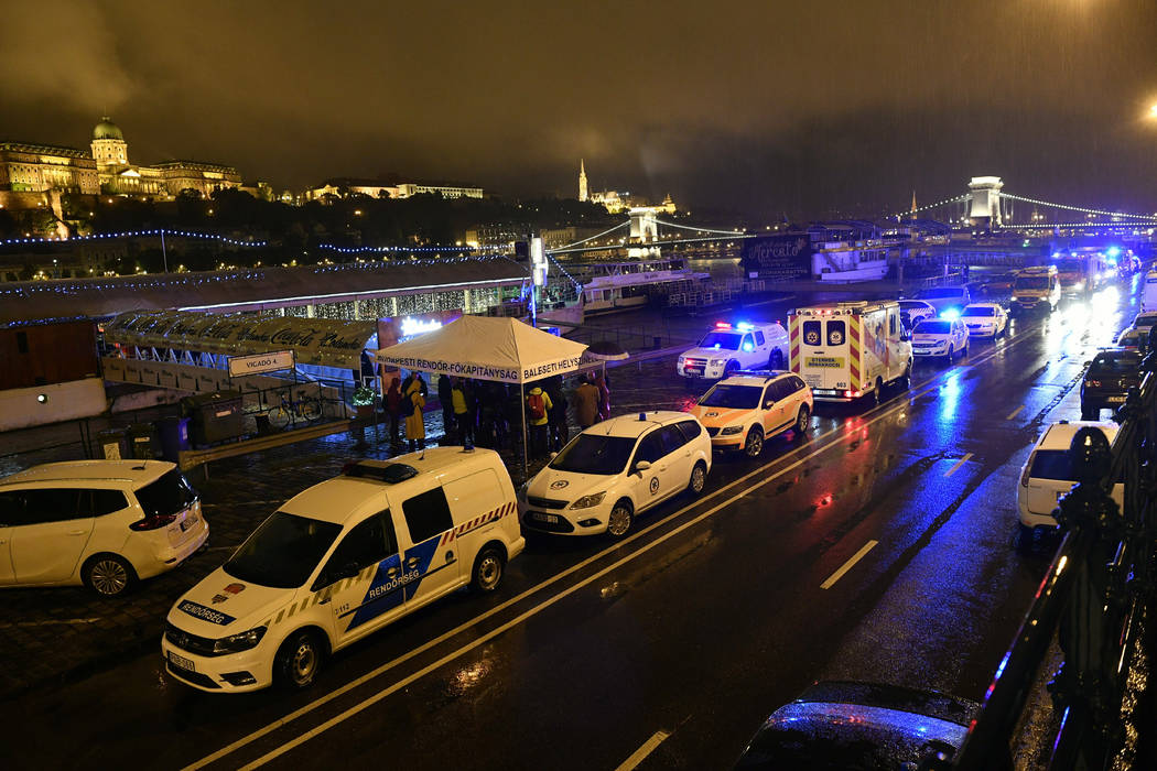 Police and ambulances are parked on the river bank early Thursday, May 30, 2019 after a tourist ...