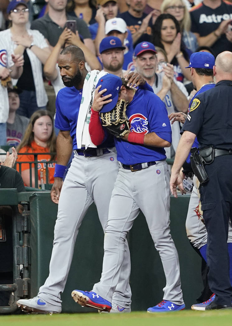 Chicago Cubs' Albert Almora Jr., right, is comforted by Jason Heyward after checking on an inju ...