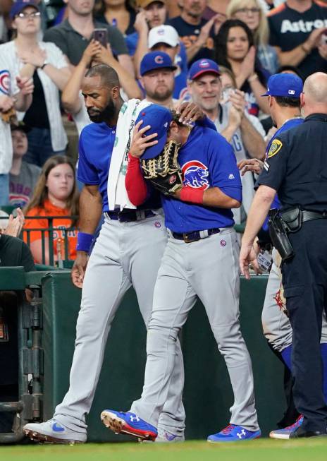 Chicago Cubs' Albert Almora Jr., right, is comforted by Jason Heyward after checking on an inju ...